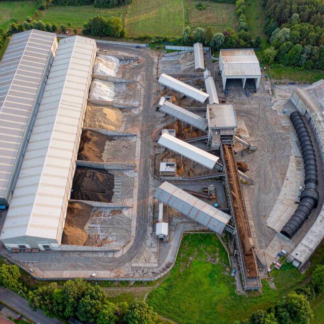 Aerial view of a resource recovery facility with material bays and surrounding countryside
